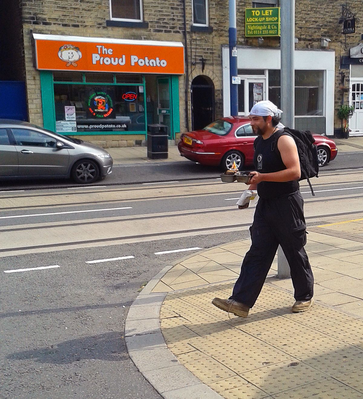 This was an image captured on my mobile. The guy was walking through the street with a flaming portable bbq in his hand complete with burger cooking. The expression of pride on his face really makes this image.